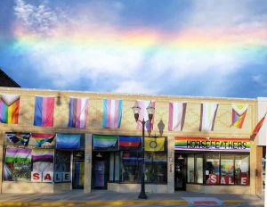 front of retail store showing Pride flags